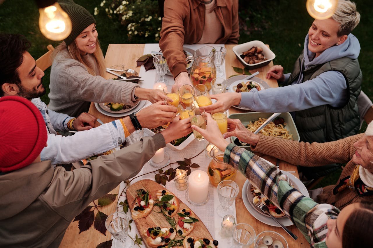 A cozy group dinner event hosted by Breaking Bread Matchmaking with diverse middle-aged individuals enjoying a meal together in a warm, inviting setting